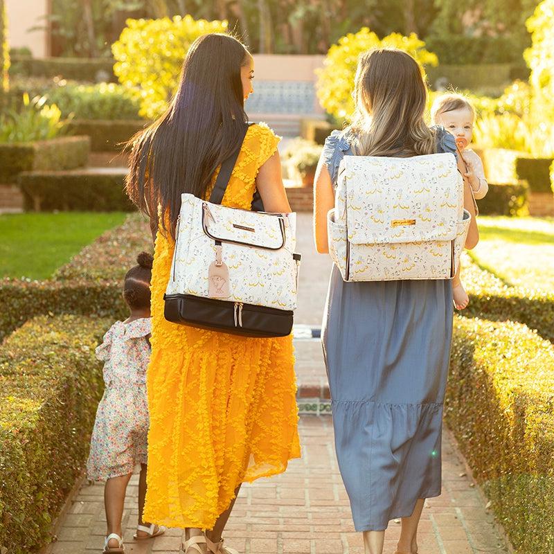 moms walking together wearing whimsical belle disney diaper bag backpacks