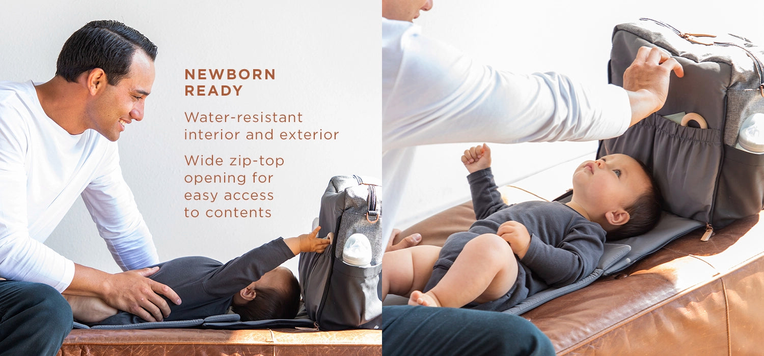 newborn ready water-resistant interior and exterior wide zip-top opening for easy access to contents. dad playing with baby on boxy backpack's diaper changing pad