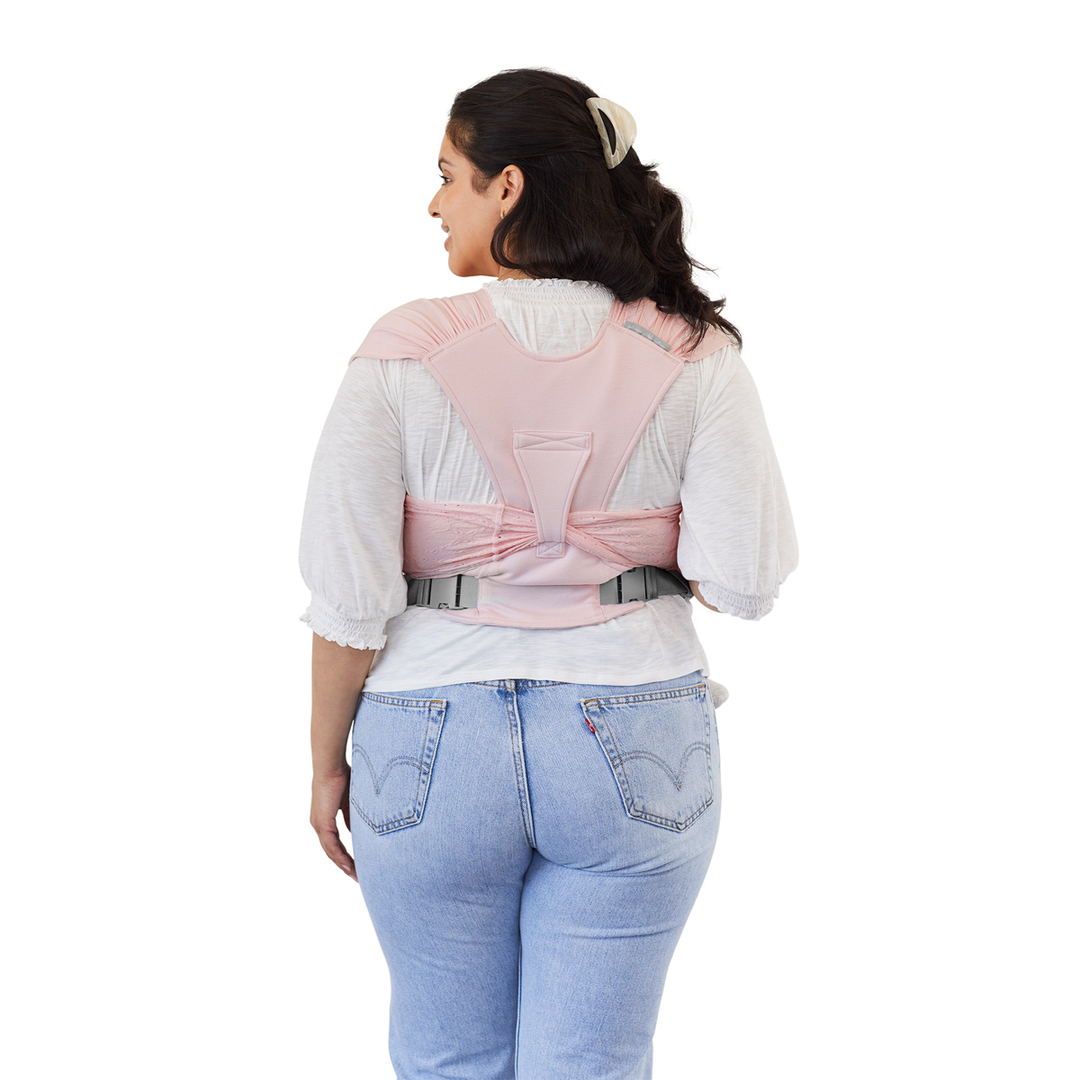 back image of mom wearing baby in Petunia Pickle Bottom x MOBY Easy Wrap Carrier in Rose Quartz Eyelet