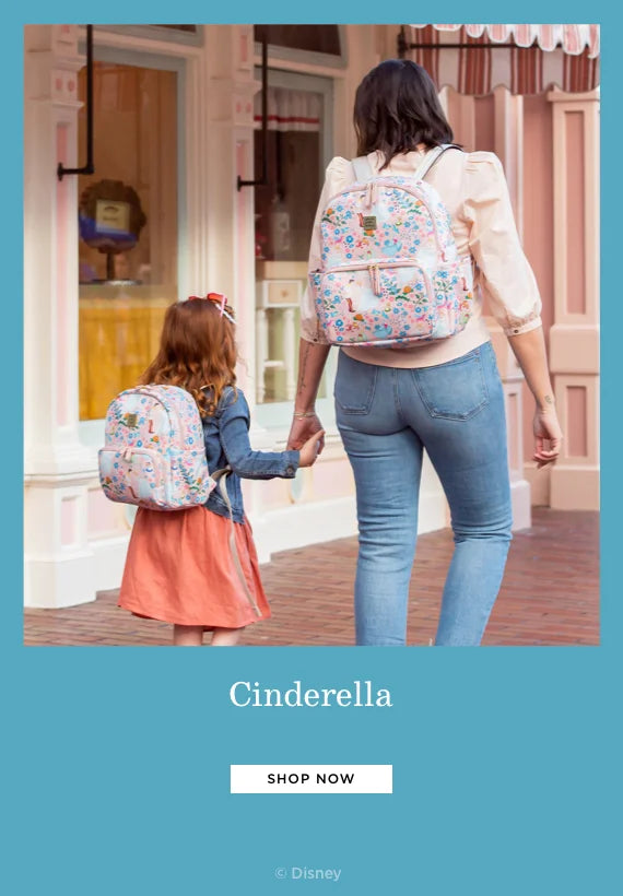 cinderella. shop now. by disney. mom wearing the district backpack in cinderella while holding toddler girl's hand who is also wearing the mini backpack in cinderella