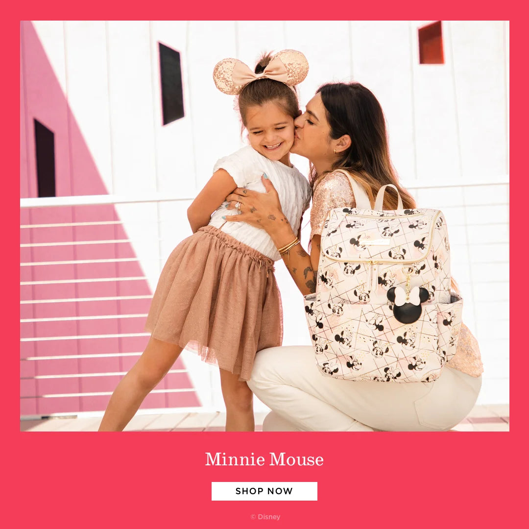 minnie mouse. shop now. by disney. mom wearing method backpack in shimmery minnie while kissing toddler girl