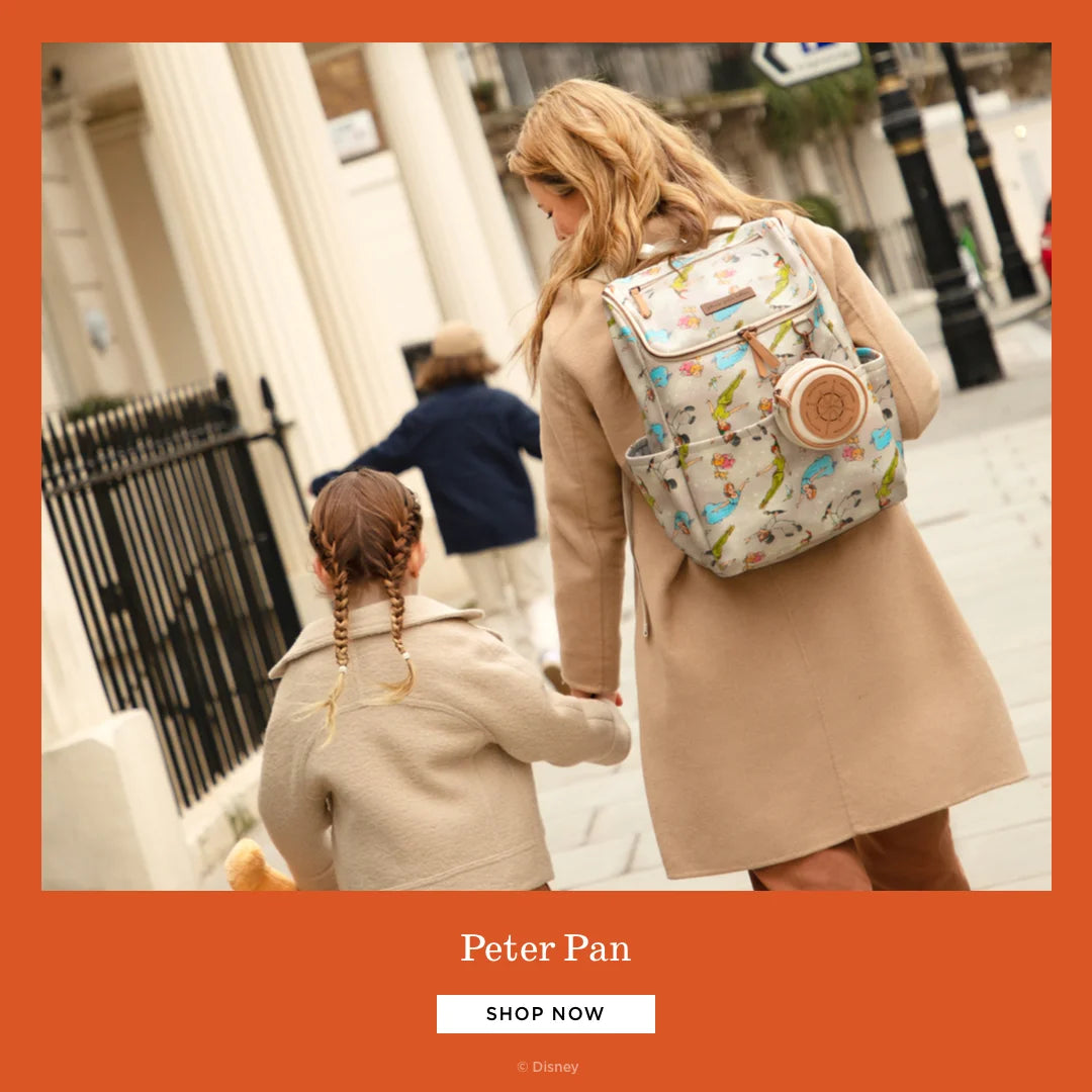 peter pan. shop now. by disney. mom wearing the method backpack in off to never land while holding toddler girl's hand