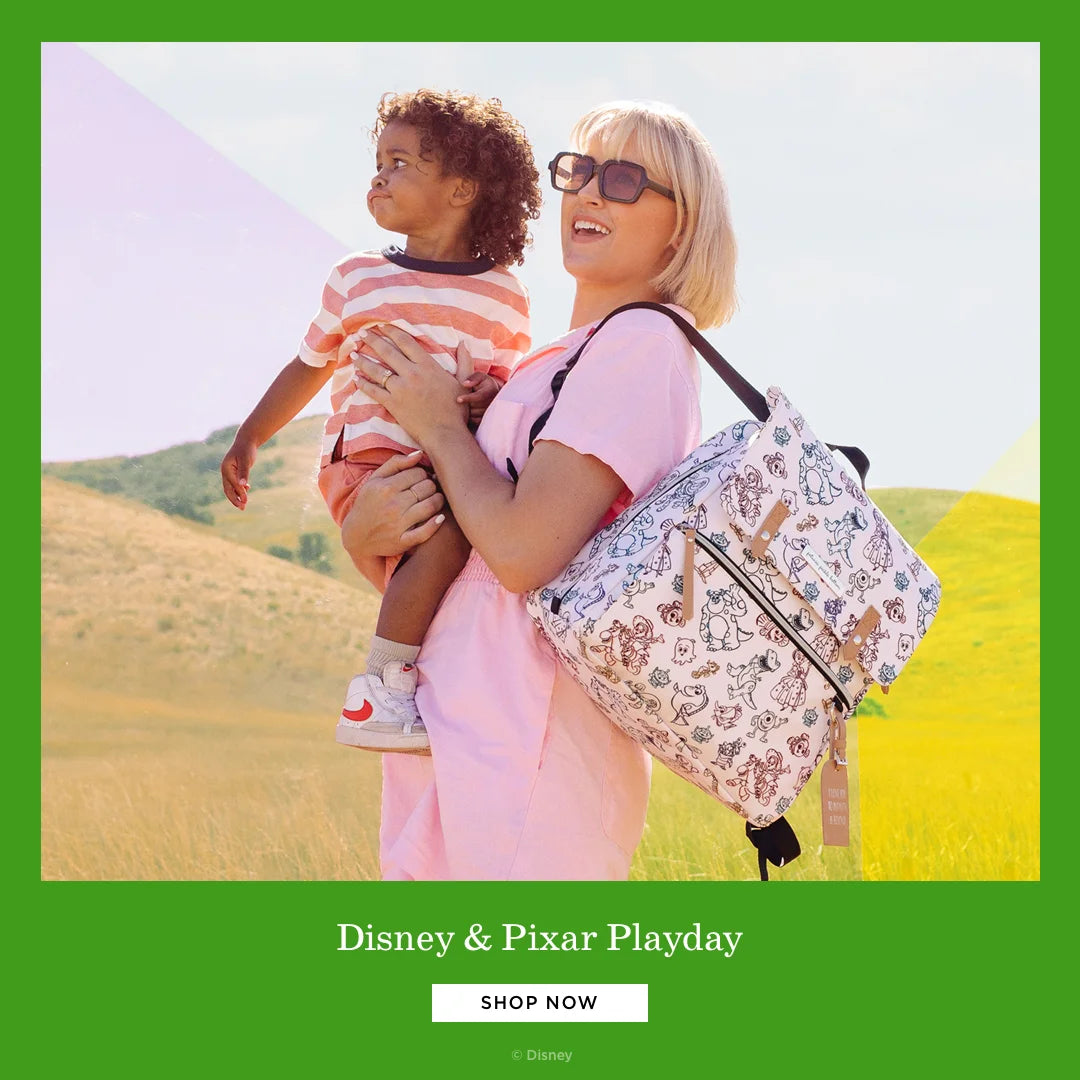 disney & pixar Playday. shop now. by disney. mom wearing the meta backpack in disney & pixar playday while holding toddler boy