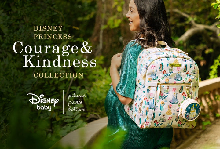 disney princess courage & kindness collection. disney baby by petunia pickle bottom. mom wearing provisions backpack in disney princess courage and kindness