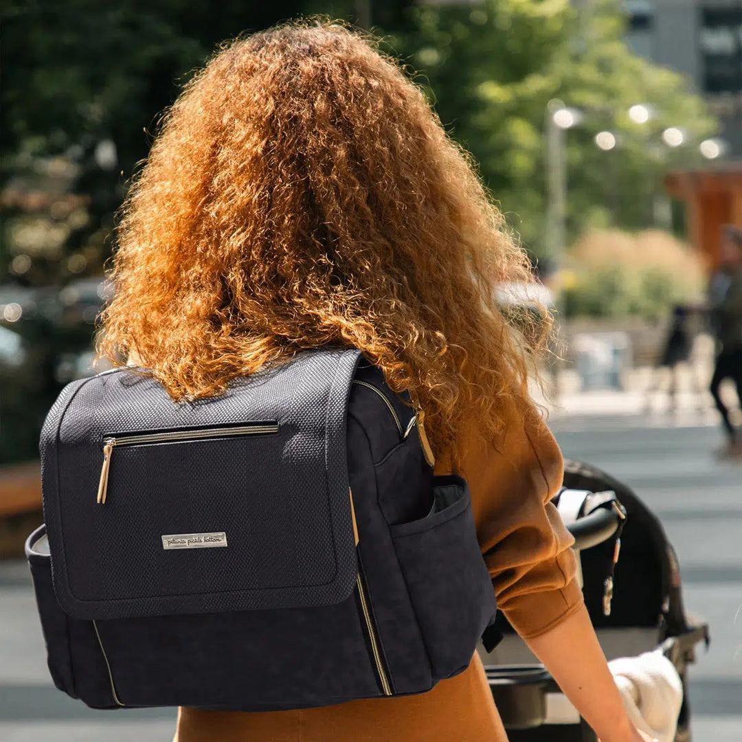 Boxy Backpack Deluxe in Carbon Cable Stitch worn by mom as backpack walking in urban environment