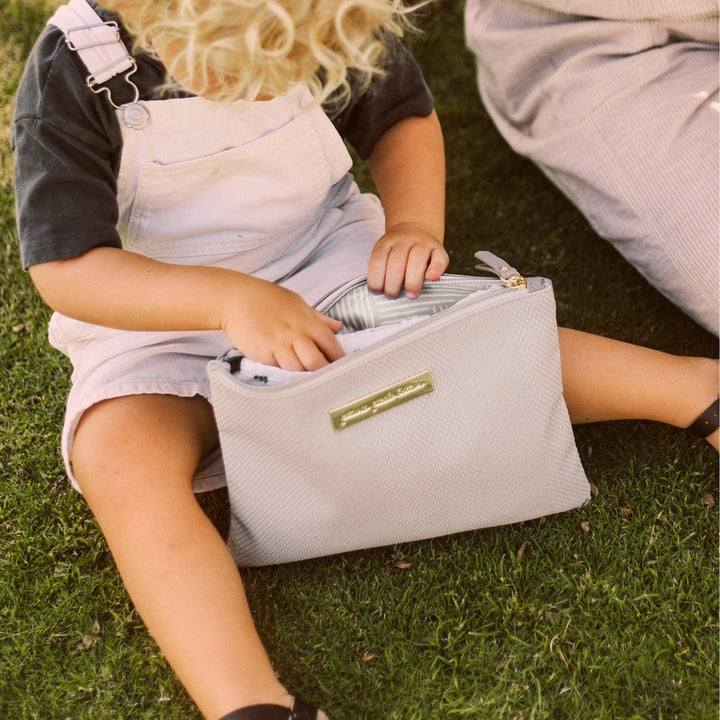 baby playing with the organizer trio in grey matte leatherette