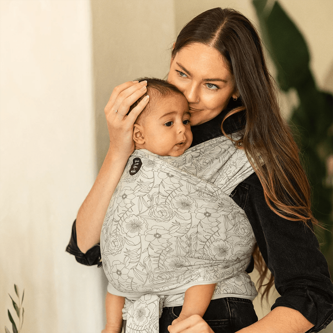 mom wearing baby  in Petunia Pickle Bottom x MOBY Classic Wrap in Seaside Poppies