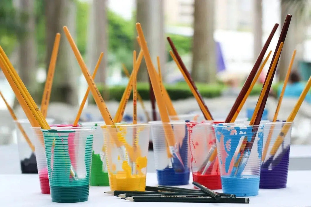 Paint Cups with brushes sticking out of them