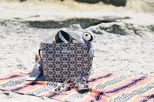 downtown tote featured on beach blanket in sand