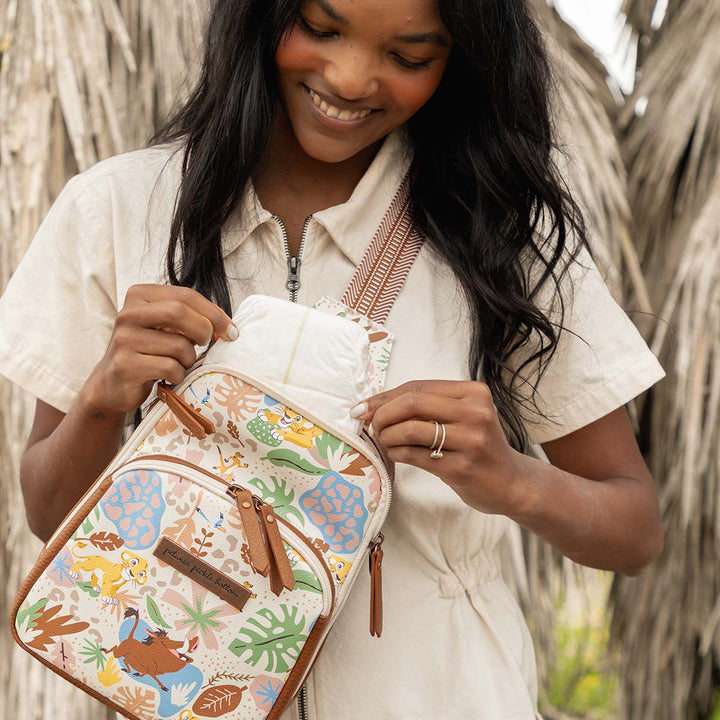 mom putting in diaper inside the Criss-Cross Sling in Hakuna Matata