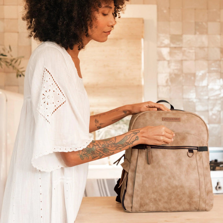 mom using the provisions backpack in brioche