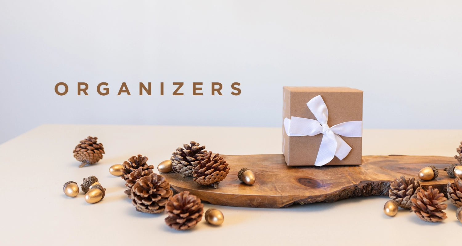 organizers. table decoration piece with pinecones and gold acorns with a small gift box