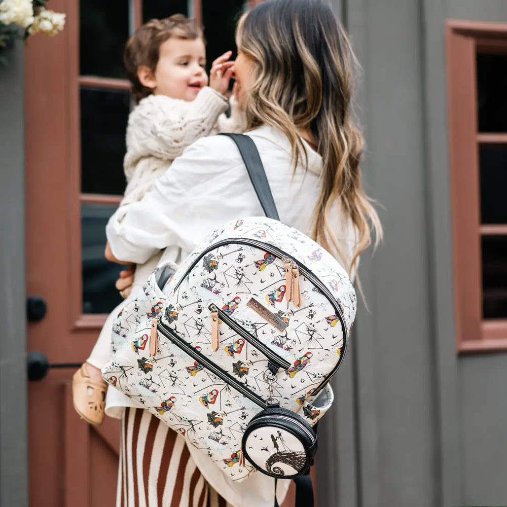 mom holding baby while wearing the Ace Backpack in Disney's Halloween Town