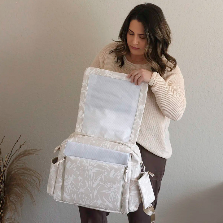 mom opening the front flap of Boxy Backpack Deluxe in Linen Blossom