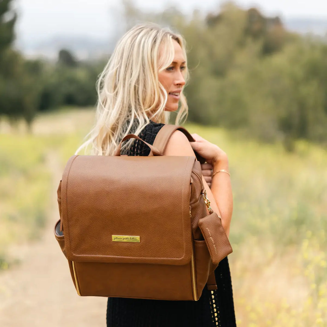 mom wearing the boxy backpack in cedar