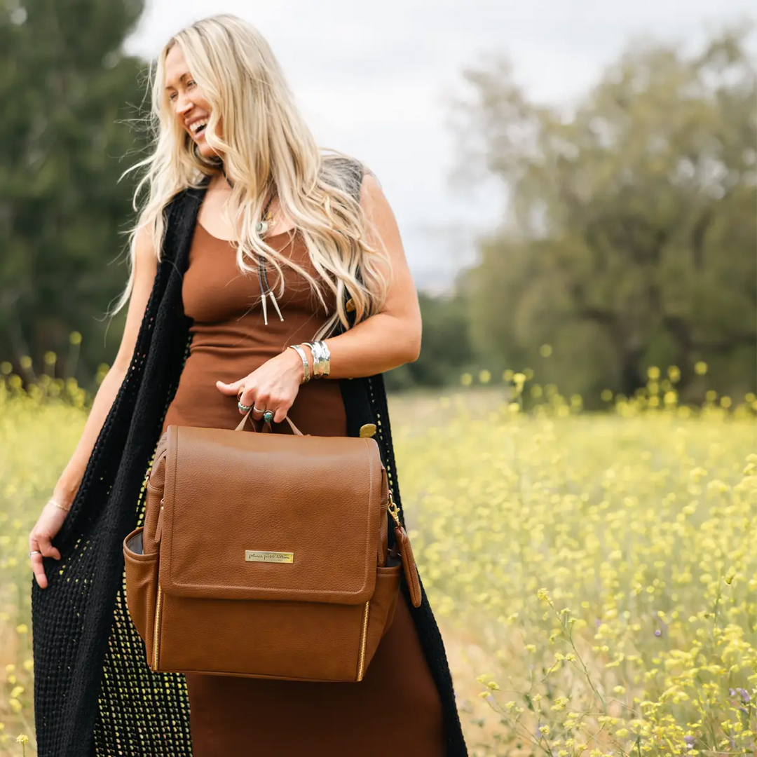 mom holding the boxy backpack in cedar