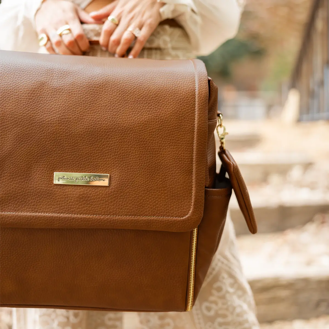 mom holding the boxy backpack in cedar