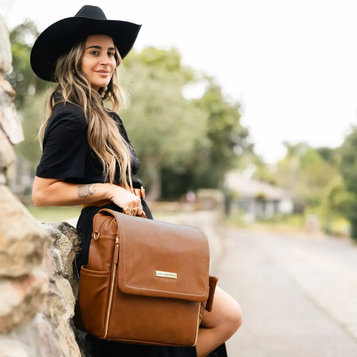 mom holding the boxy backpack in cedar