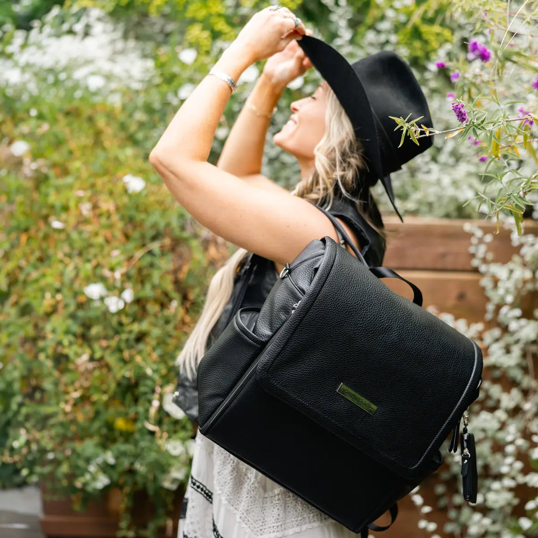 mom wearing the boxy backpack in ebony