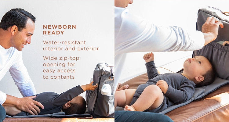 newborn ready water-resistant interior and exterior wide zip-top opening for easy access to contents. dad playing with baby on boxy backpack's diaper changing pad