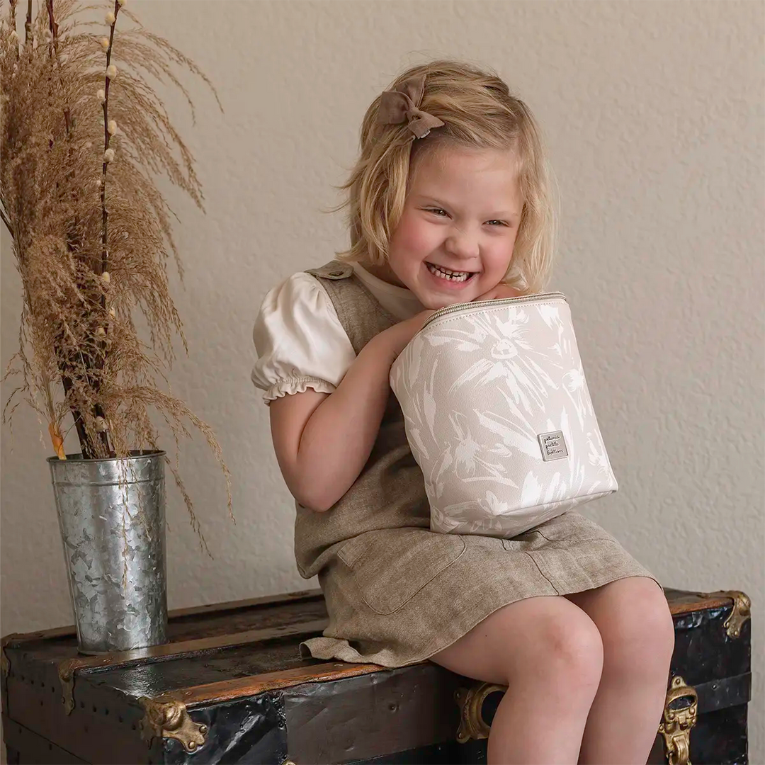 toddler holding the Cool Pixel Plus in Linen Blossom