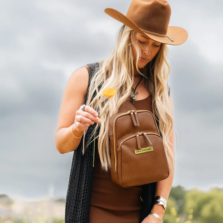 mom wearing the criss-cross sling in cedar