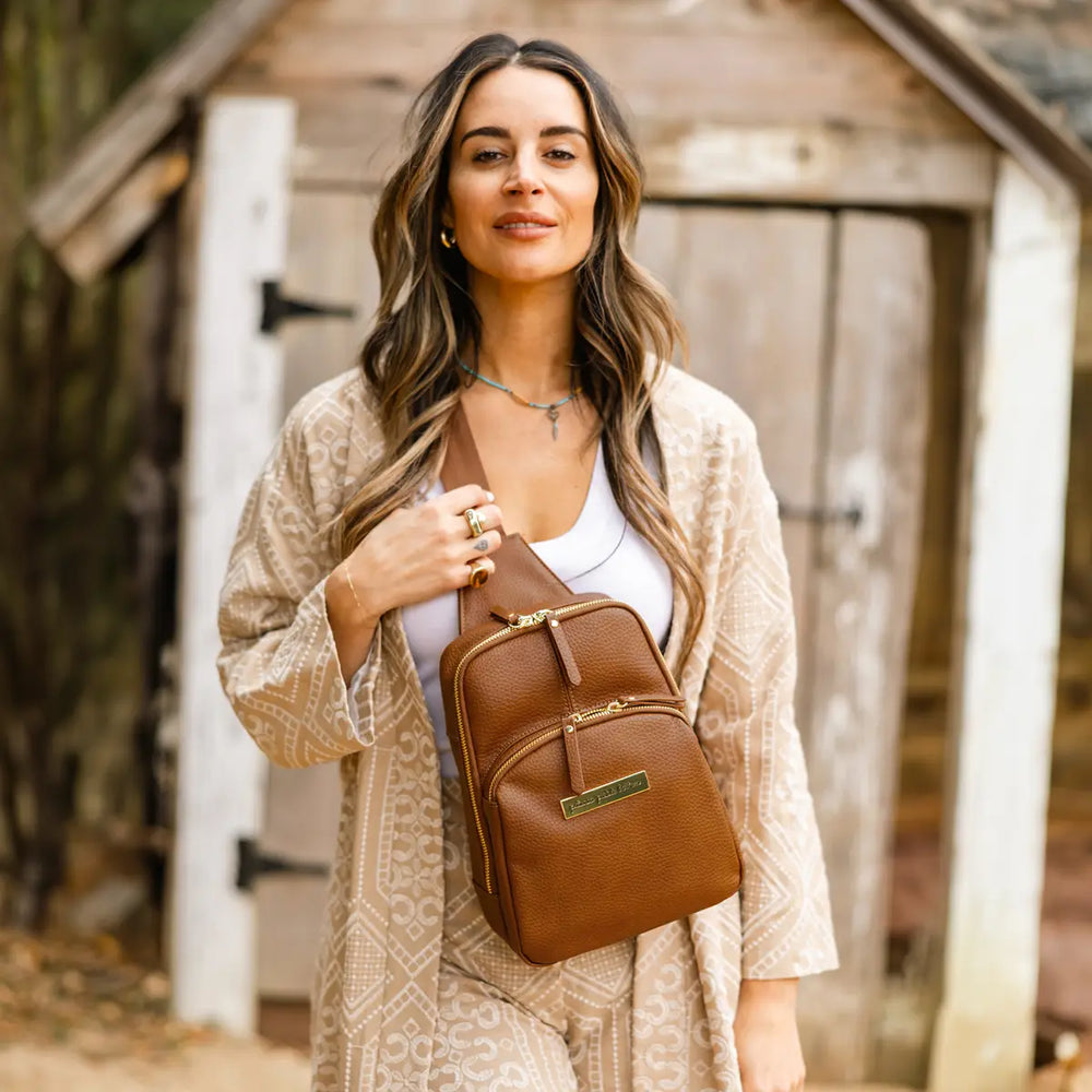 mom wearing the criss-cross sling in cedar