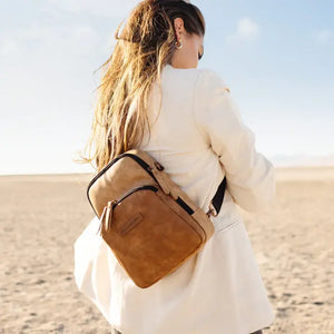 mom wearing criss-cross sling mini backpack in brioche color