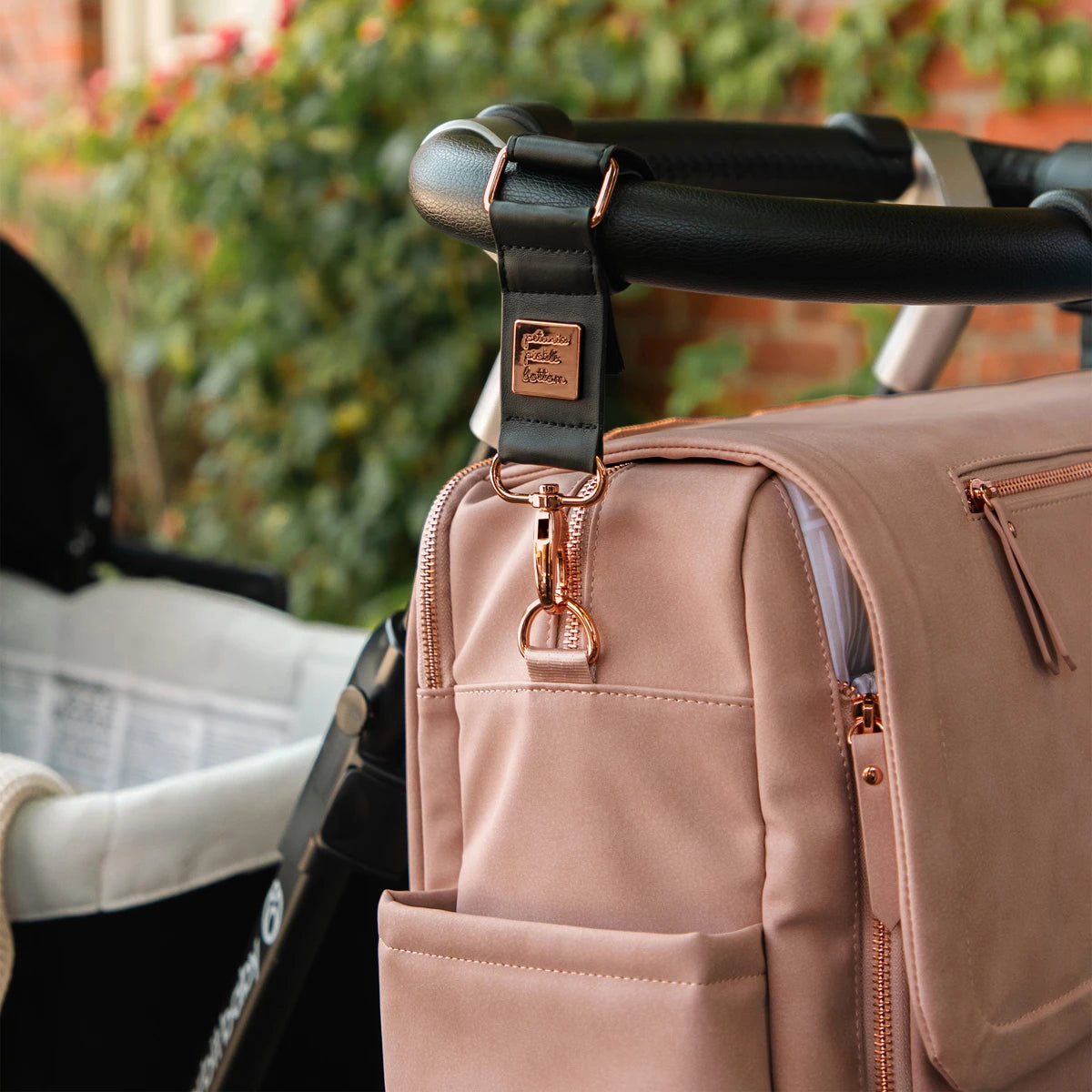 boxy backpack deluxe in toffee rose attached to stroller with valet stroller clips