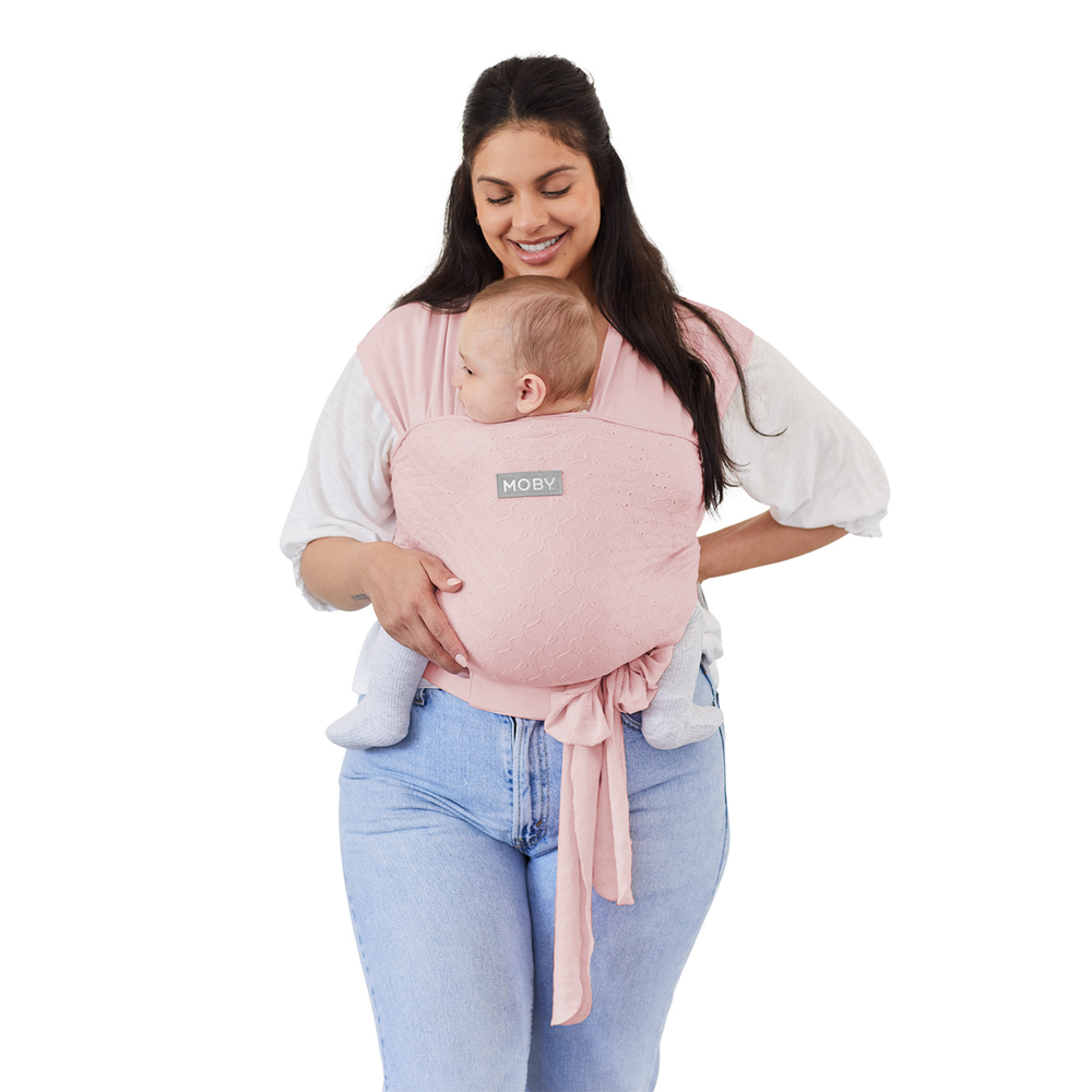 mom wearing baby in Petunia Pickle Bottom x MOBY Easy Wrap Carrier in Rose Quartz Eyelet