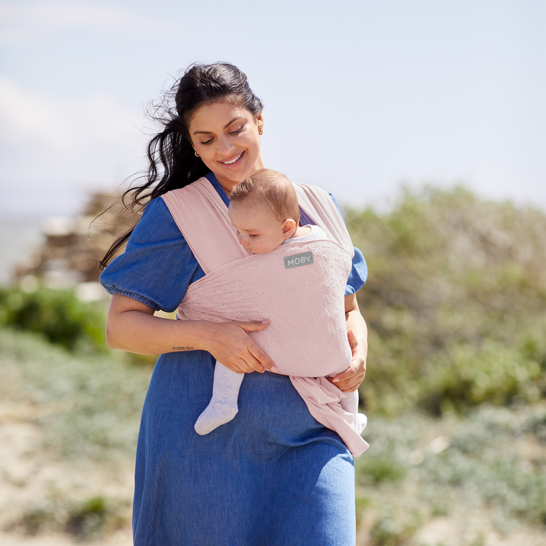 mom wearing baby in Petunia Pickle Bottom x MOBY Easy Wrap Carrier in Rose Quartz Eyelet