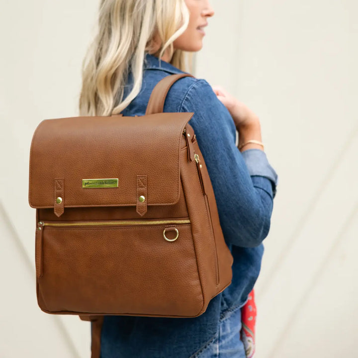 mom wearing the meta backpack in cedar