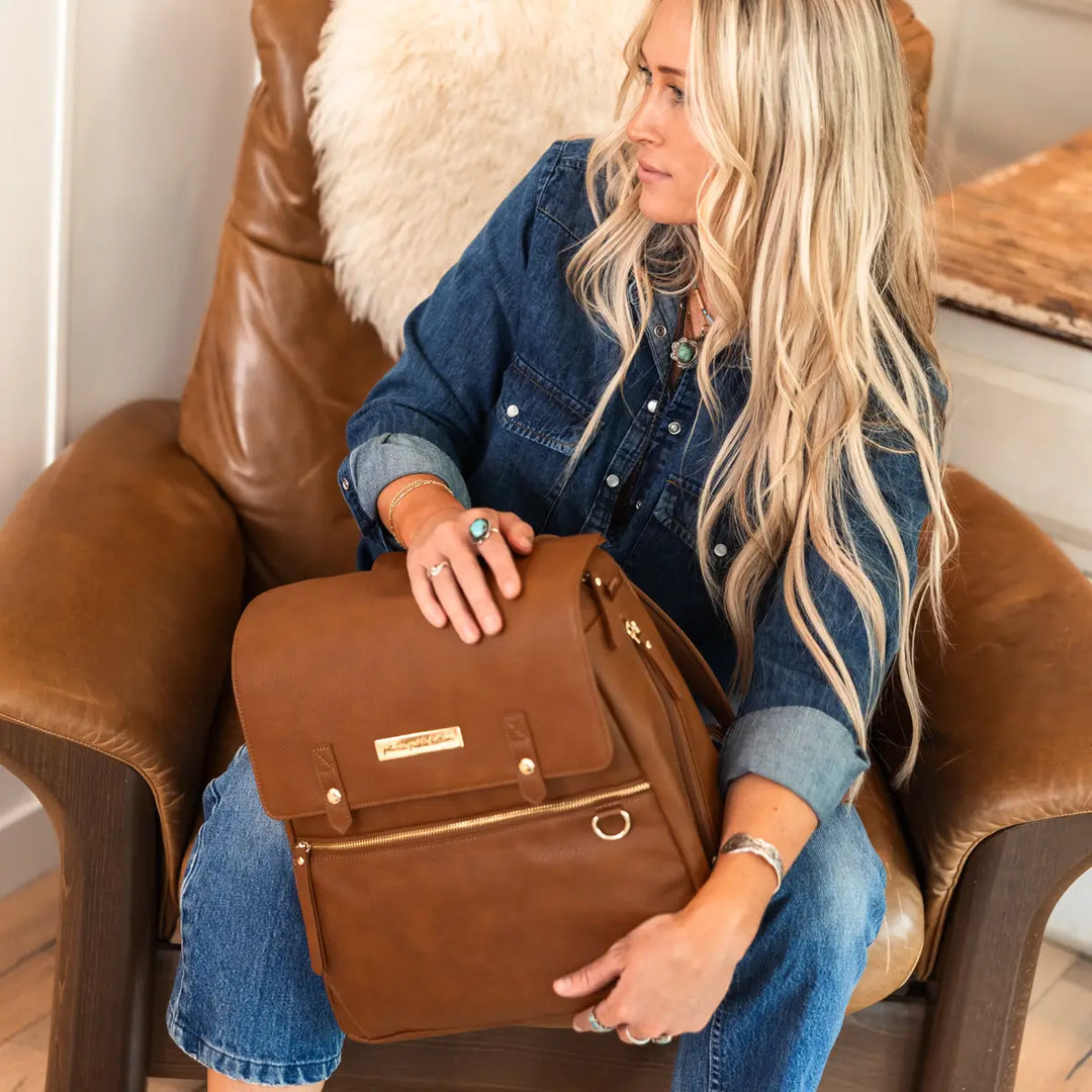 mom holding the meta backpack in cedar