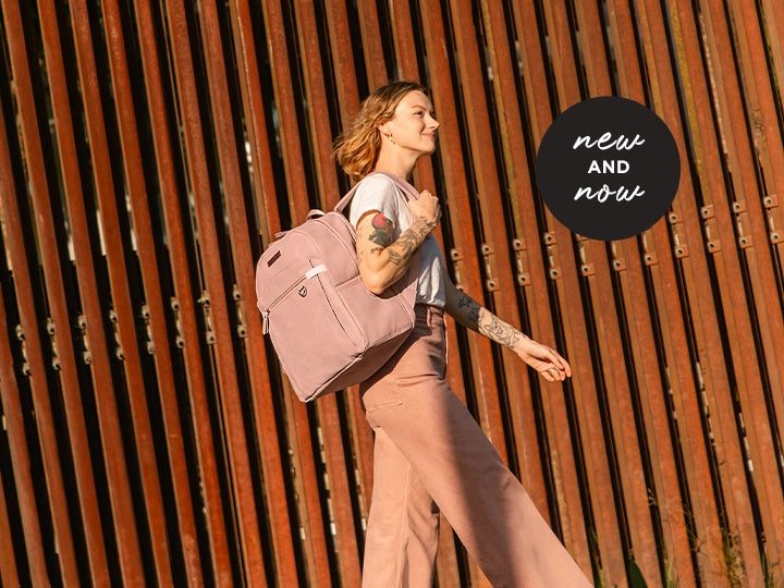 new and now. action shot of mom walking while wearing the provisions backpack in toffee rose