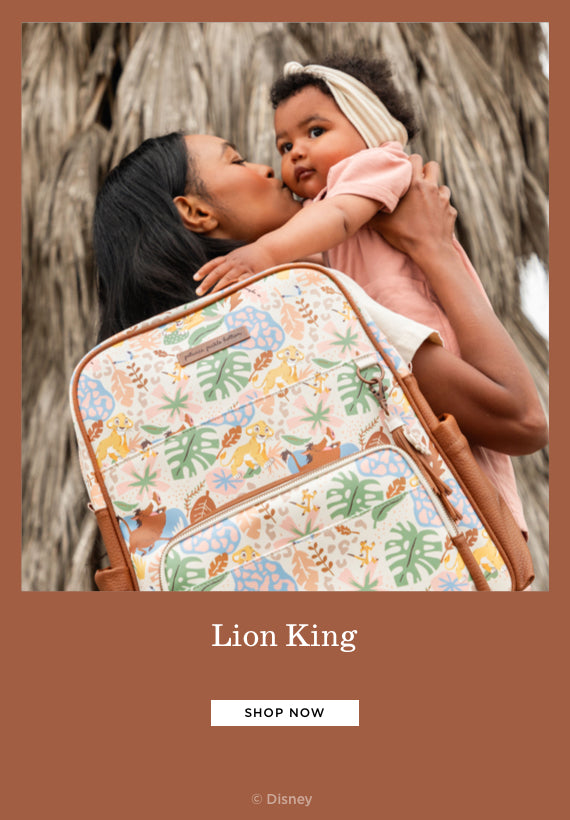 lion king mom holding baby while wearing the sync backpack in hakuna matata