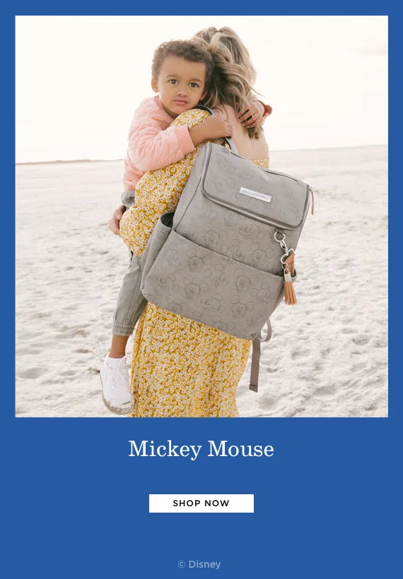 mickey mouse. shop now. by disney. mom wearing the method backpack in love mickey while holding toddler boy
