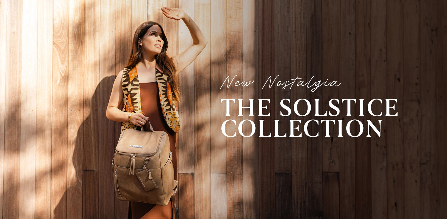 new nostalgia the solstice collection. mom holding the tempo backpack in mink
