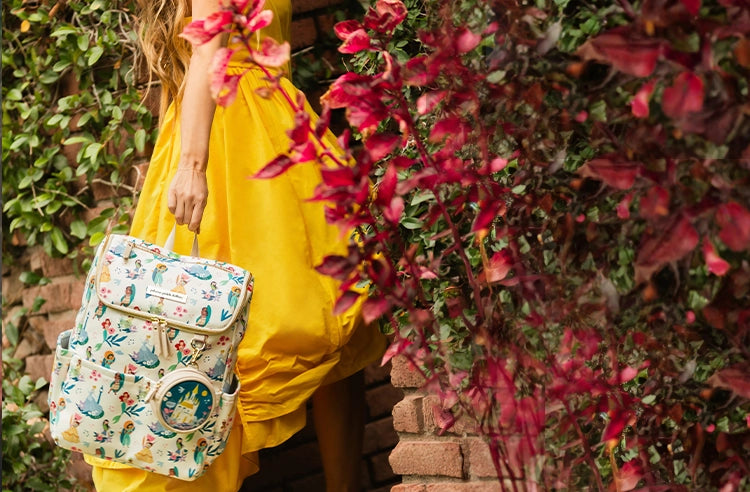 mom with yellow dress holding the method backpack in disney princess courage and kindness