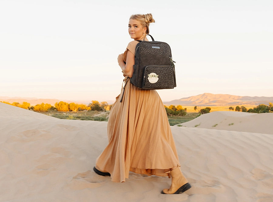 mom wearing the sync backpack in the child