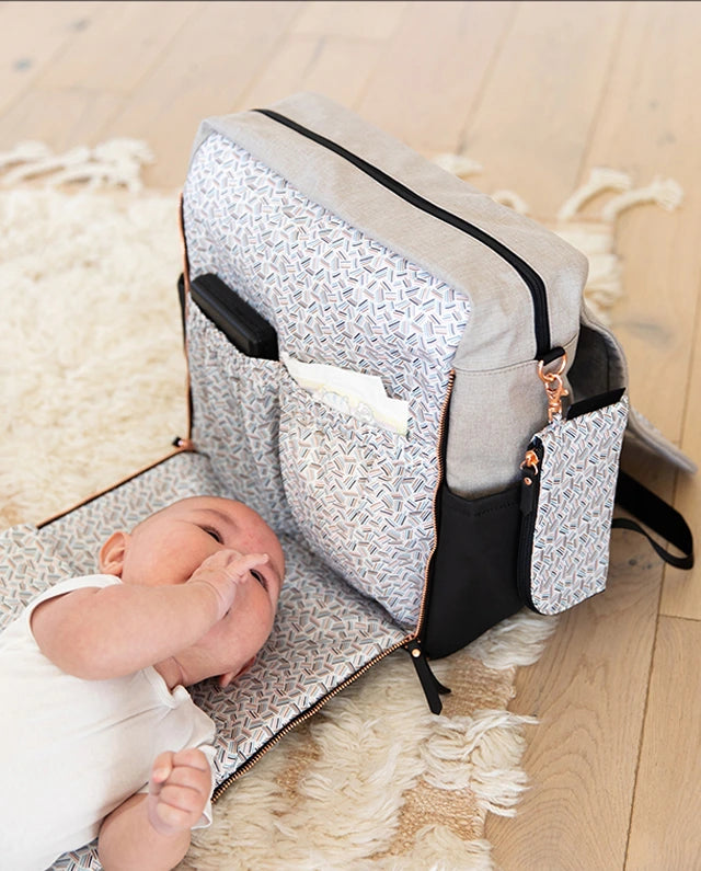 Boxy Backpack with zip out changing pad expanded to show baby diaper changing feature
