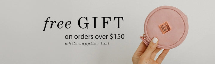 free gift on orders over $150 while supplies last. hand is holding the petite porter in toffee rose