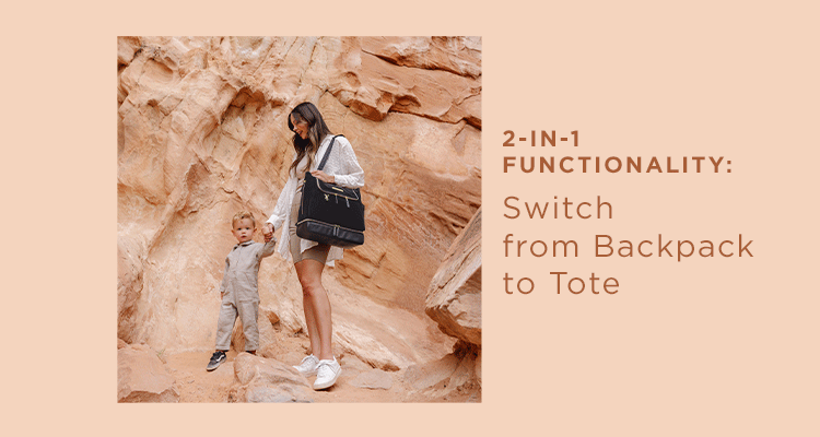 2-in-1 functionality: switch from backpack to tote. mom holding baby while wearing the pivot backpack in twilight black