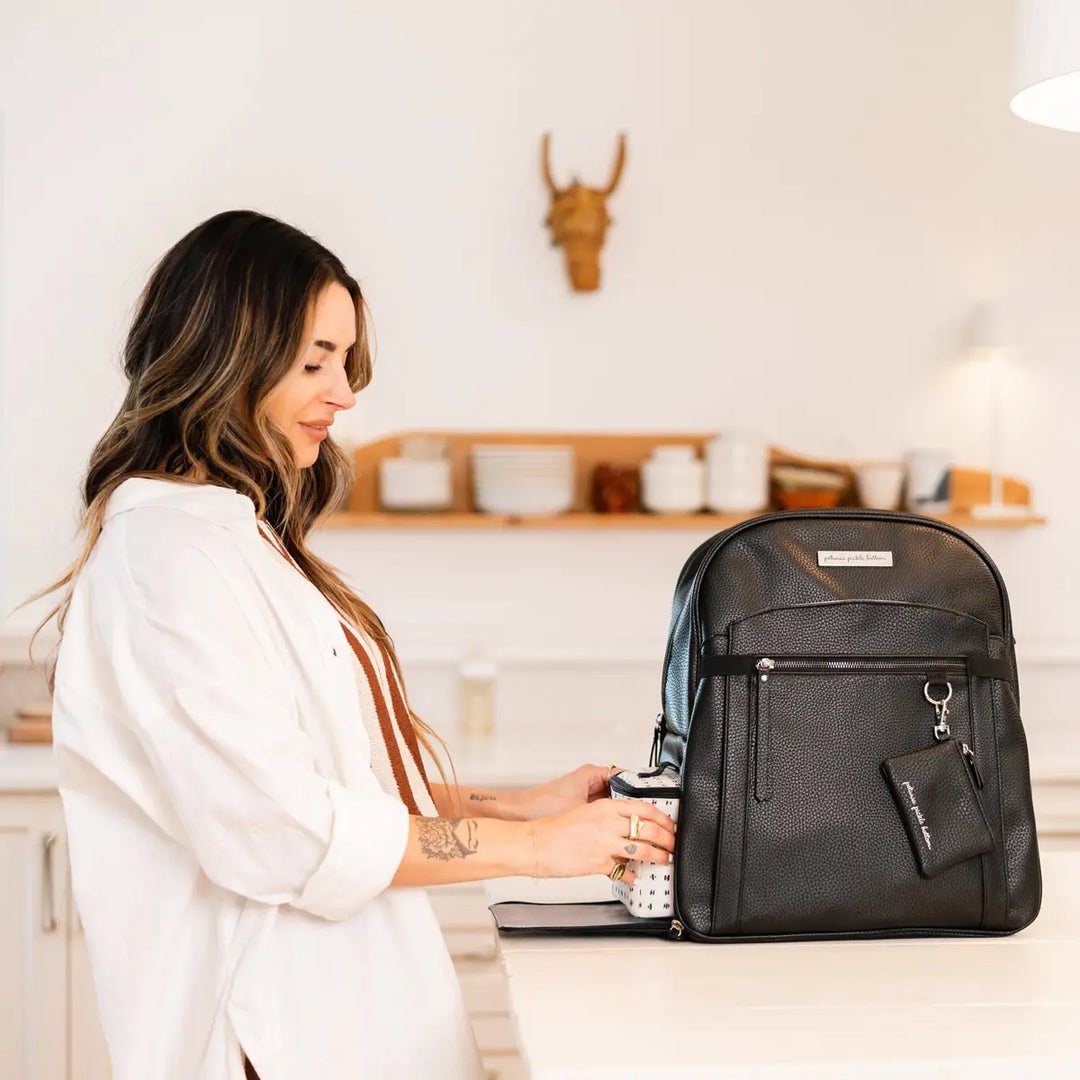 mom wearing the provisions backpack in ebony