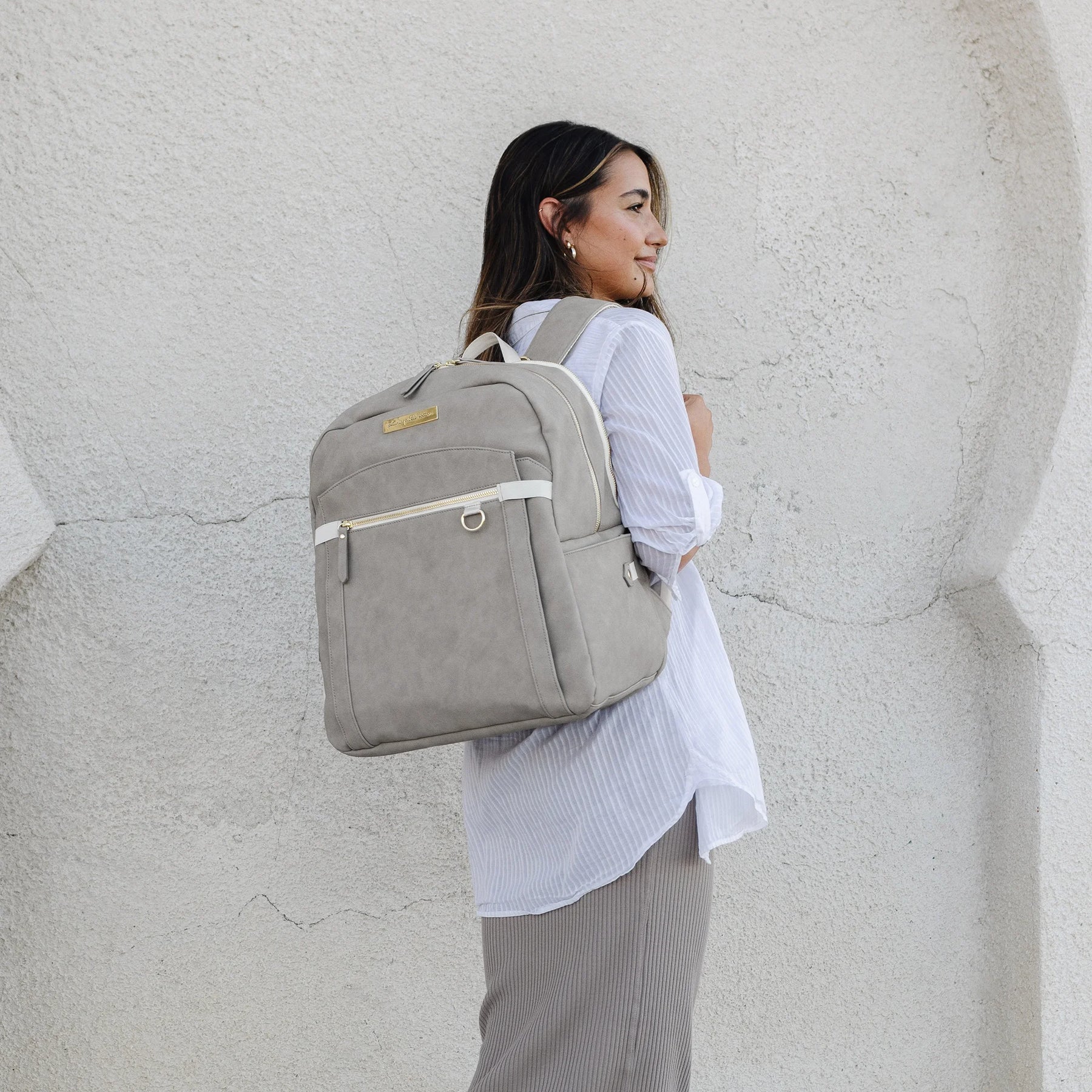 mom wearing the provisions backpack in grey matte leatherette