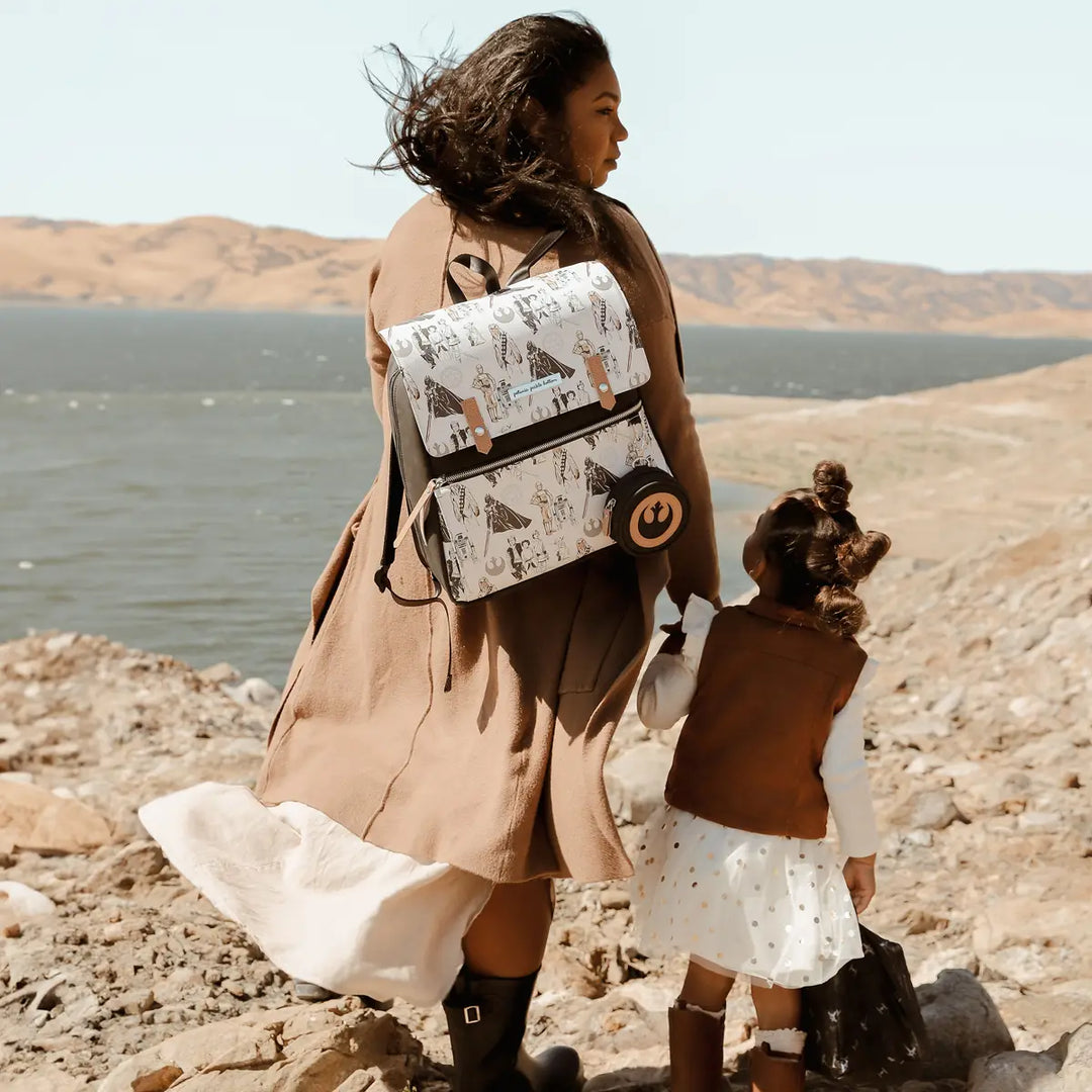 mom wearing the Meta Backpack in The Star Wars Collection while holding hands with girl