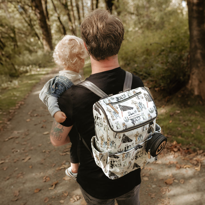 dad wearing the Method Backpack in The Star Wars Collection while holding baby