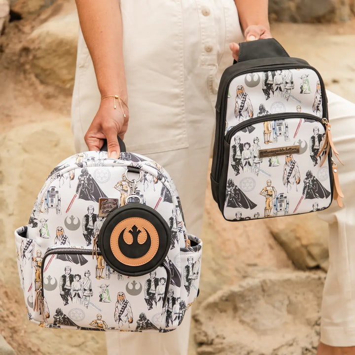 mom holding the  Mini Backpack in The Star Wars Collection and the criss-cross sling