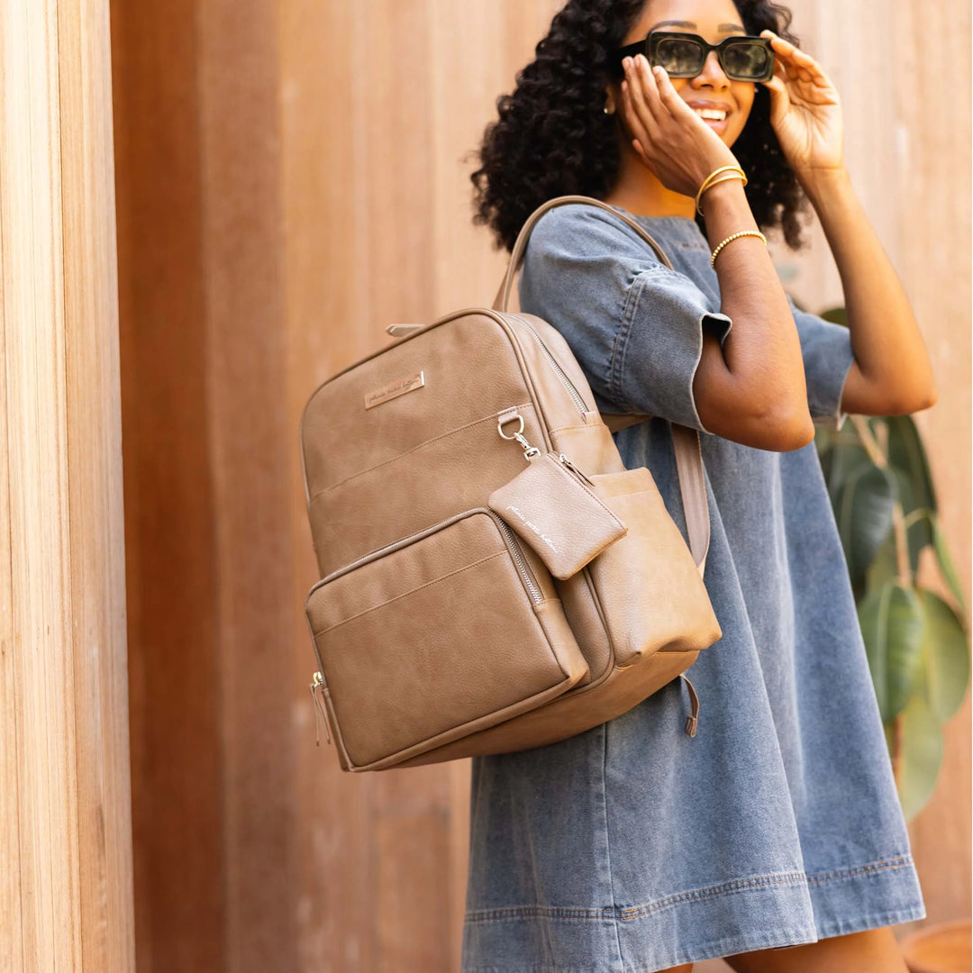 mom with the Sync Backpack in Mink over her shoulder