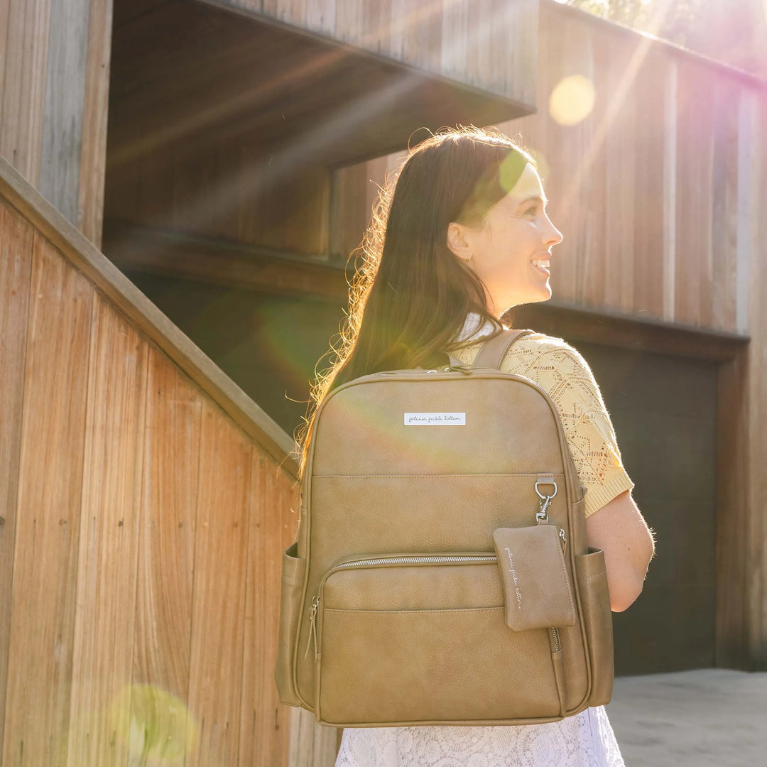 mom wearing the Sync Backpack in Mink a cool-toned greige.