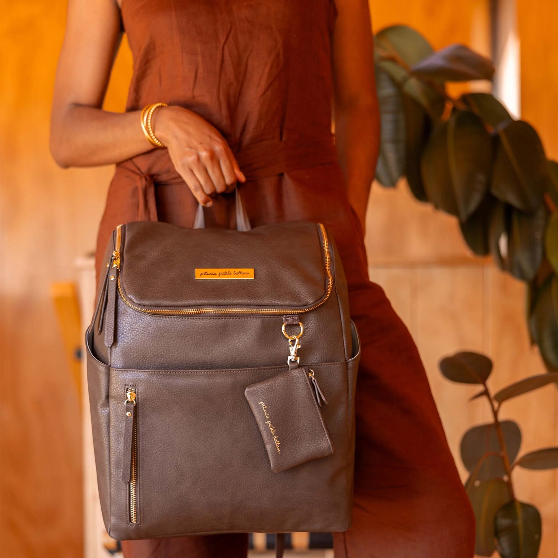 mom holding tempo backpack in saddle